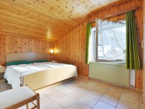 a bedroom with a bed and a window at Apartment Cincelli - Marmolada by Interhome in Pozza di Fassa
