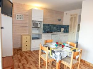 a kitchen with a table and chairs in a room at Apartment Port Richelieu 4-2 by Interhome in Cap d'Agde