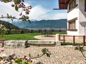 a stone patio with mountains in the background at Apartment Golden by Interhome in Sanzeno