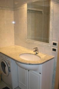 a bathroom with a sink and a washing machine at Apartment Spinel by Interhome in Campitello