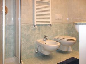 a bathroom with a toilet and a sink at Apartment Spinel by Interhome in Campitello