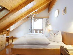 a bedroom with a large bed in a attic at Apartment Ardoney-2 by Interhome in Campitello