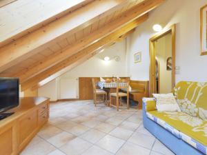 a living room with a couch and a table at Apartment Ardoney-2 by Interhome in Campitello