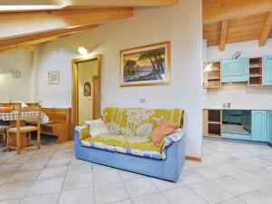 a living room with a couch and a kitchen at Apartment Ardoney-2 by Interhome in Campitello