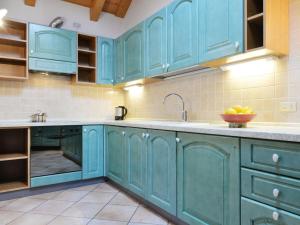 a kitchen with blue cabinets and a sink at Apartment Ardoney-2 by Interhome in Campitello