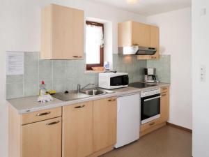 a kitchen with a sink and a microwave at Apartment Haupthaus Schönblick - SVH116 by Interhome in San Valentino alla Muta