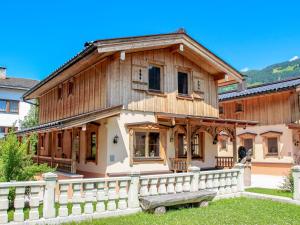 a wooden house with a fence in front of it at Holiday Home Schwendau-2 by Interhome in Hippach