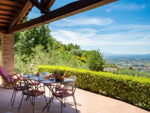 a table and chairs on a patio with a view at Holiday Home Il Sorbino by Interhome in Fondaccio