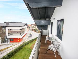 a balcony with chairs and a view of a building at Apartment Schallhart by Interhome in Terfens