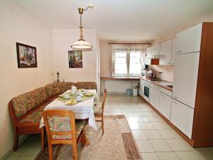 eine Küche und ein Esszimmer mit einem Tisch und einem Sofa in der Unterkunft Holiday Home Friedl by Interhome in Ritzing