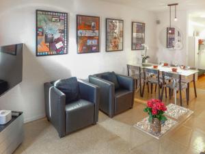 a living room with two chairs and a table at Apartment Jeanne D'Arc Apt- C-19 by Interhome in Crans-Montana