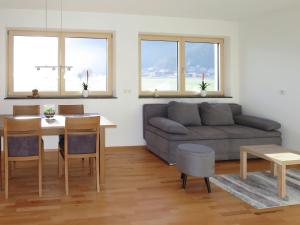 a living room with a couch and a table at Apartment Zillertalblick - FGZ230 by Interhome in Strass im Zillertal