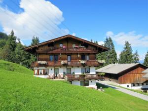 a large house with balconies on a green hill at Apartment Luxner - KAB137 by Interhome in Kaltenbach