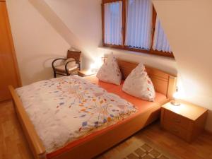 a small bedroom with a bed and a window at Apartment Dieboldshof by Interhome in Neuried