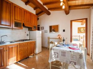 a kitchen with a table with a white table cloth at Holiday Home Piccola Oasi 3 by Interhome in Capoliveri