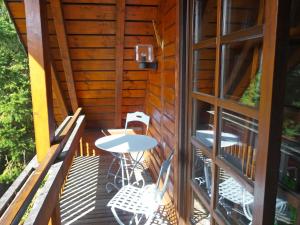 a deck with a table and chairs and a window at Apartment Albergo Natura by Interhome in Hüfingen