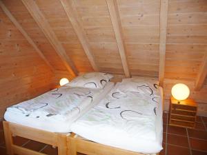 a bedroom with two beds in a wooden room at Apartment Albergo Natura by Interhome in Hüfingen