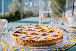 a pie on a glass plate on a table at Villa Eris Amalfi Coast in Conca dei Marini