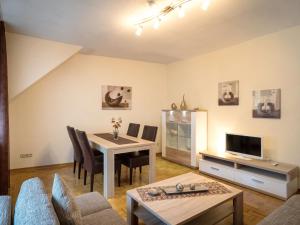 a living room with a table and a dining room at Apartment Weingut Krempel by Interhome in Traben-Trarbach