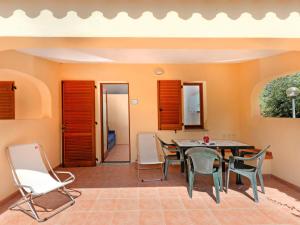 a dining room with a table and chairs at Apartment 4 Mori- Residence - MUV100 by Interhome in Costa Rei