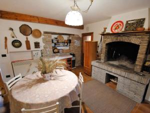 a dining room with a table and a fireplace at Holiday Home Maria Rosaria by Interhome in Ginestreto