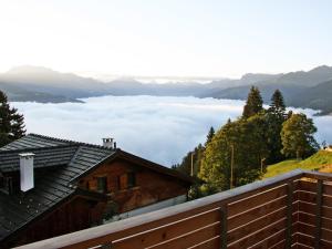 a view of a valley of clouds from a house at Chalet Börtji by Interhome in Furna