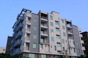 a tall apartment building with balconies on it at Hotel Girija Sunrise in Deoghar