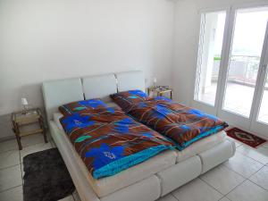 a bed in a room with a large window at Apartment Hegglistrasse 9-1 by Interhome in Buochs