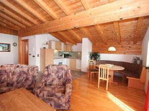 ein Wohnzimmer mit Tisch und Stühlen und eine Küche in der Unterkunft Apartment Hansjörg-4 by Interhome in Gattererberg + 13 Fotos