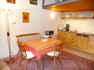 a kitchen with a table and two chairs and a table at Apartment Rosengarten by Interhome in Sterneck +8 photos