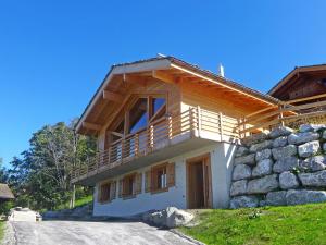 a house with a balcony on the side of it at Chalet Chalet Jadi by Interhome in Nendaz