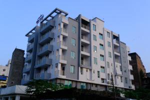 a building with balconies on the side of it at Hotel Girija Sunrise in Deoghar