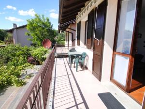 a balcony of a house with a table and chairs at Apartment Blue Lagoon by Interhome in  Monvalle 