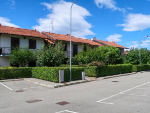 a building with a parking lot in front of it at Apartment Blue Lagoon by Interhome in  Monvalle 