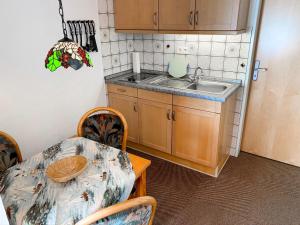 a small kitchen with a table and a sink at Apartment Dehne-1 by Interhome in Norddeich