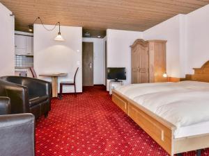um quarto com uma cama, uma secretária e uma mesa em Apartment Chalet Abendrot-7 by Interhome em Grindelwald