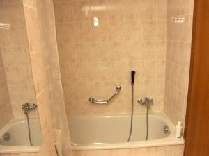 a bath tub in a bathroom with a shower at Apartment Les Rocailles by Interhome in Anzère