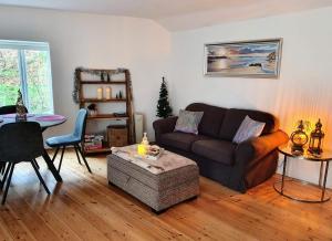 a living room with a couch and a table at Riverside Cottage with sauna in Barnstaple