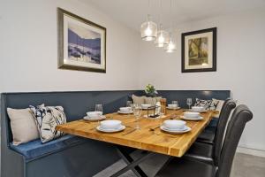 a dining room with a wooden table and black chairs at Clovelly House Relaxed Family Coastal Home in Berwick-Upon-Tweed