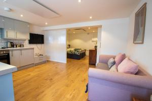 a large living room with a couch and a kitchen at Stylish Studio in the Heart of the English Riviera in Torquay