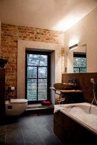 a bathroom with a tub and a sink and a bath tub at Wassermühle Deppendorf in Bielefeld