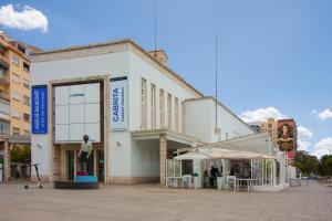 a large white building with a statue in front of it at SW Soho Family Apartment in Málaga