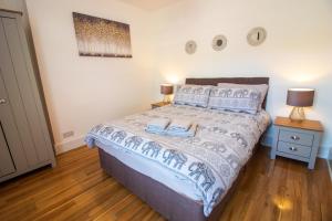 a bedroom with a bed with two books on it at Stylish Home in the heart of the English Riviera in Torquay