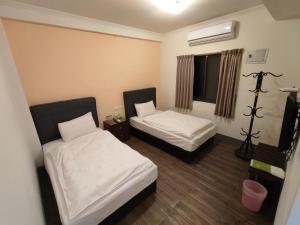 Postel nebo postele na pokoji v ubytování 莒光英雄館民宿 B&b
