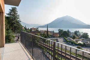 a balcony with a view of a city and a mountain at Residenza Luigina in Varenna