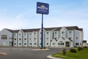 a large building with a sign in front of it at Microtel Inn & Suites Lincoln in Lincoln