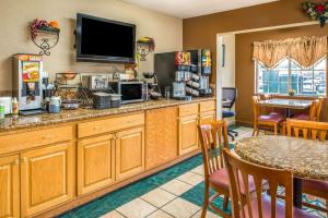 a kitchen with a counter with a television and a table at Microtel Inn & Suites Lincoln in Lincoln