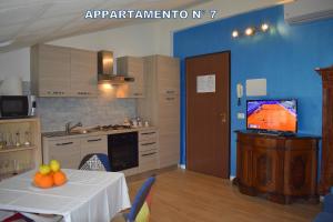 a kitchen with a table with fruit on it at Red & Blu Apartments in Desenzano del Garda