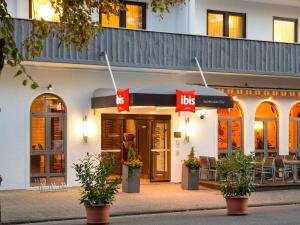 a store with aoks sign in front of a building at ibis Saarbrücken City in Saarbrücken