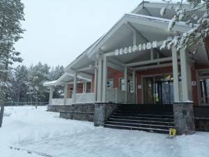 a building with snow in front of it at Baza Otdyha Lesnaya in Apatity